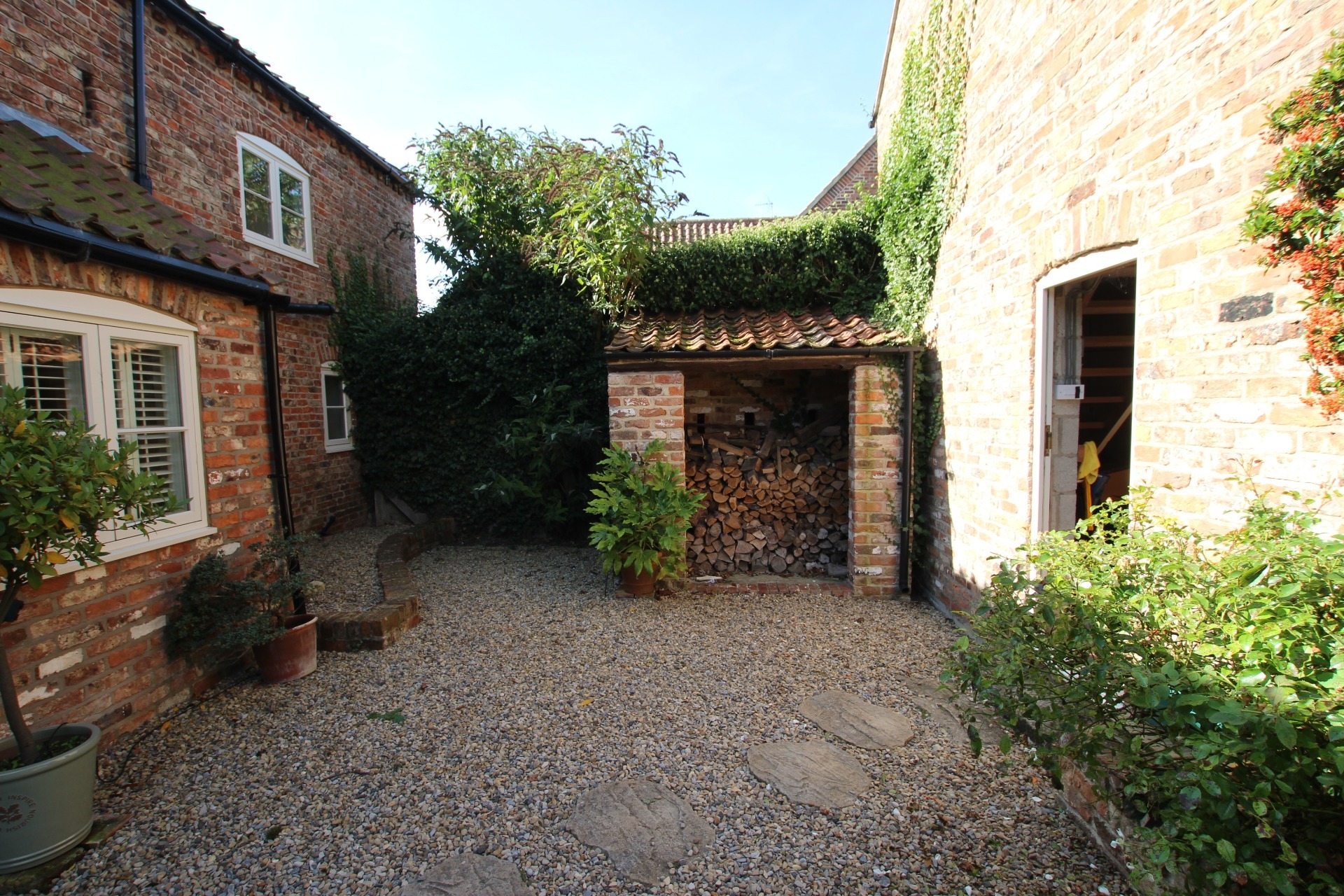 Gap between main house and outbuildings before constructing linking extension